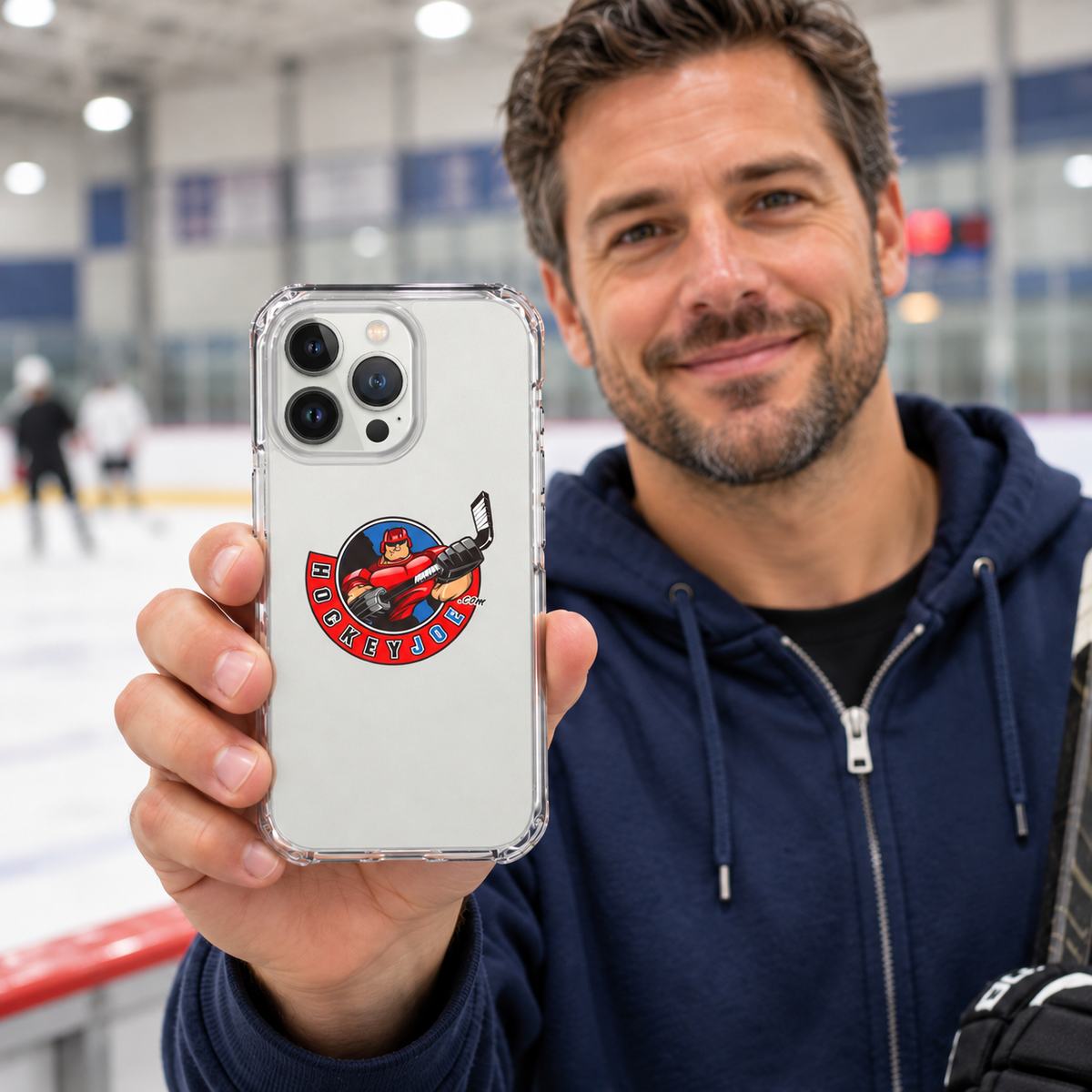 Hockey Joe clear case for iPhone 13 Pro Max — rink-side lifestyle mockup; phone not included