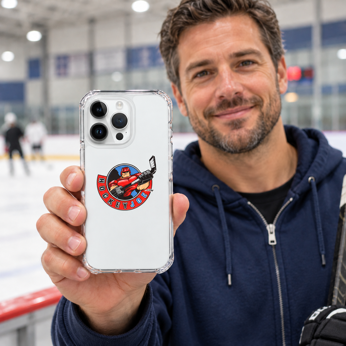 Hockey Joe clear case for iPhone 14 Pro Max — rink-side lifestyle mockup; phone not included