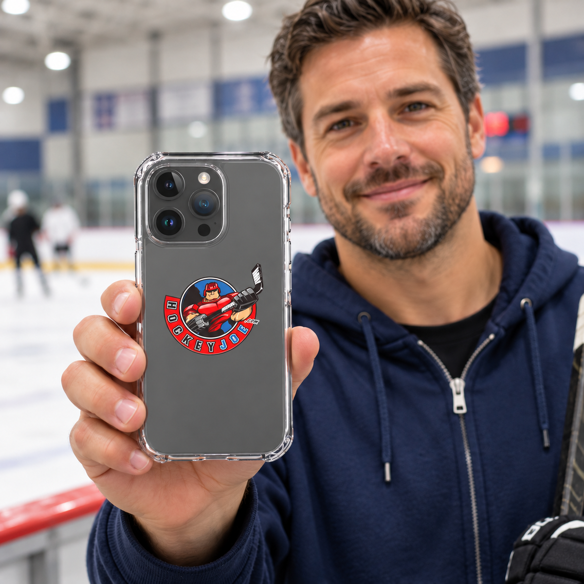 Hockey Joe clear case for iPhone 15 Pro Max — rink-side lifestyle mockup; phone not included