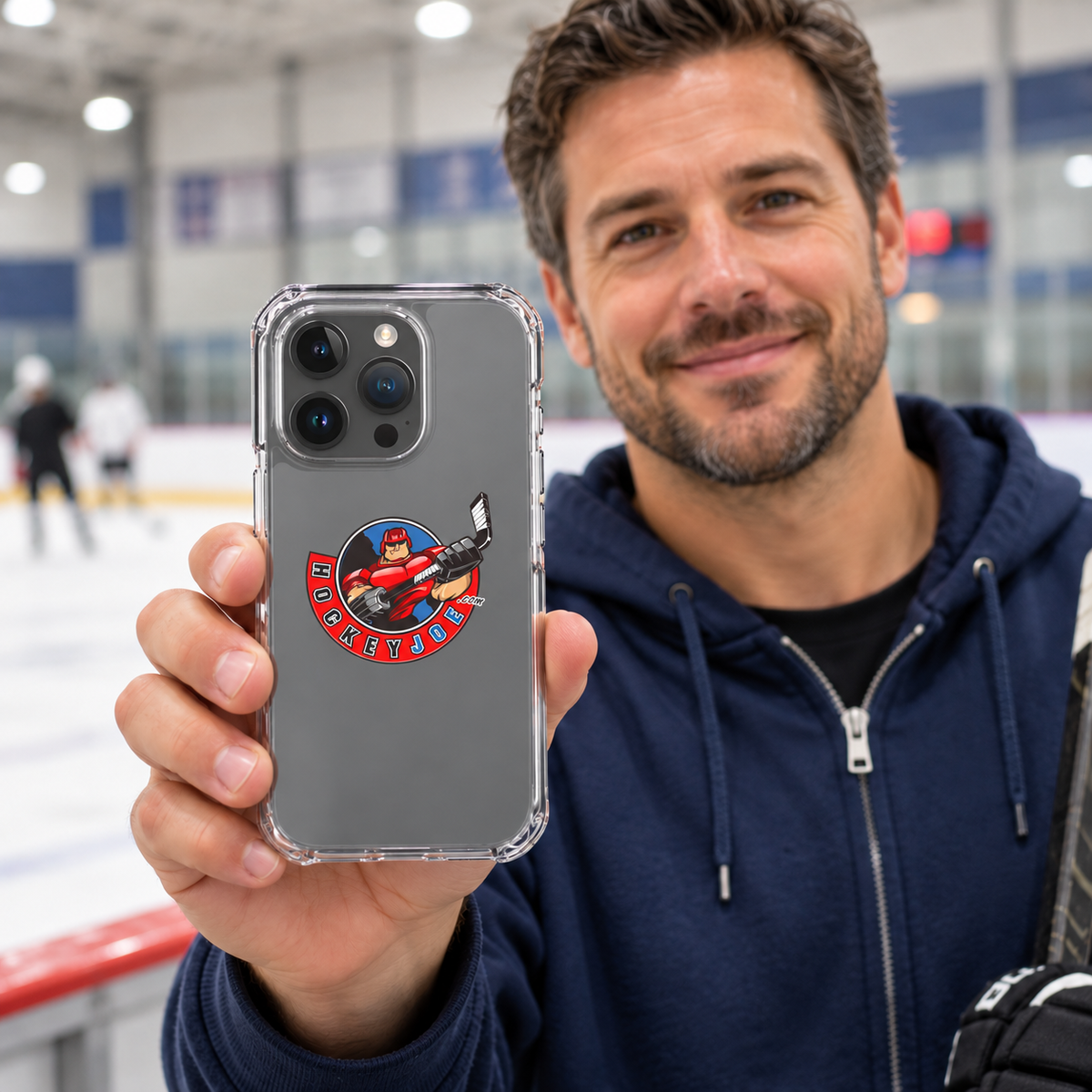 Hockey Joe clear case for iPhone 15 Pro — rink-side lifestyle mockup; phone not included