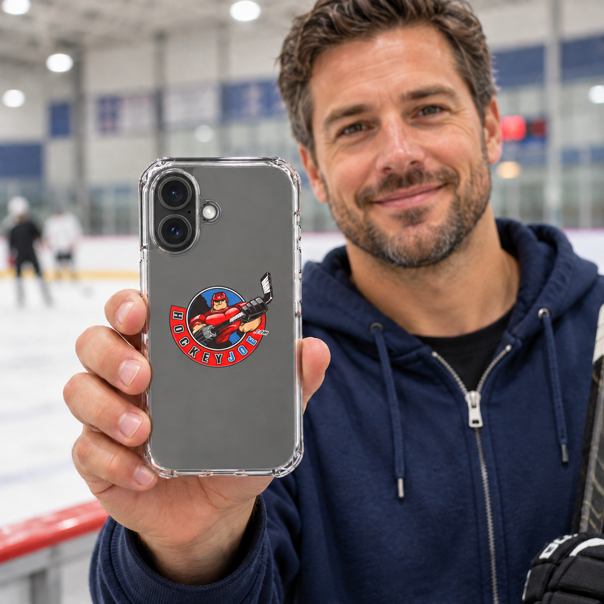 Hockey Joe clear case for iPhone 16 — rink-side lifestyle mockup; phone not included