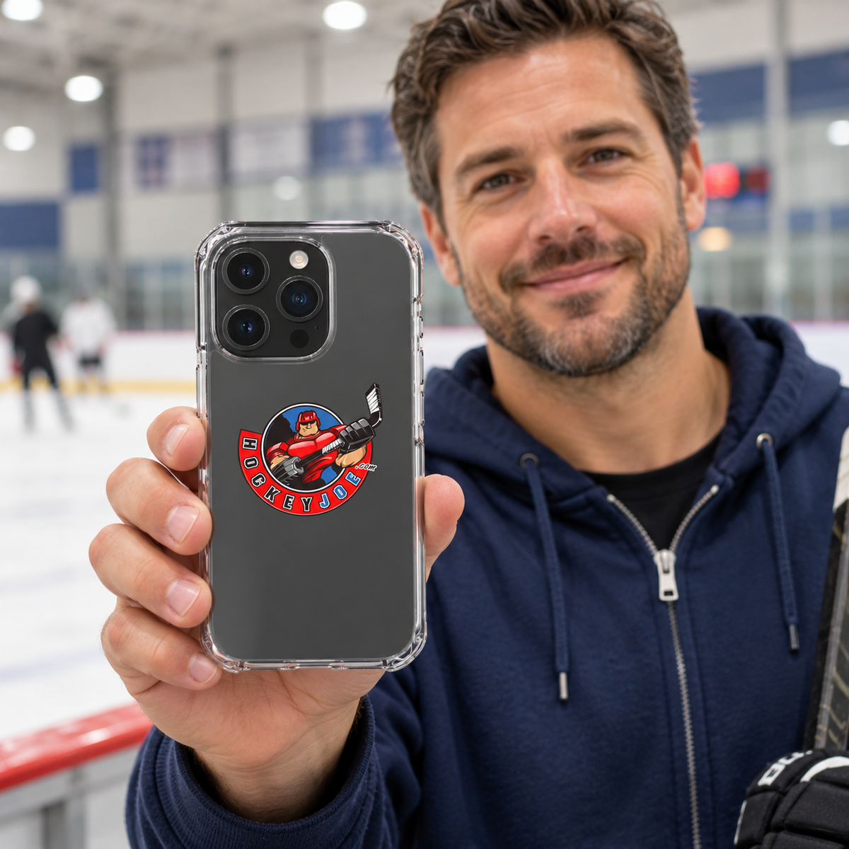 Hockey Joe clear case for iPhone 16 Pro — rink-side lifestyle mockup; phone not included