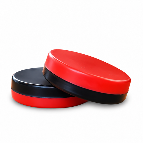 Two red and black custom team-color hockey wax discs on a white background